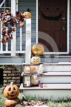 Halloween pumpkins and decorations outside a house