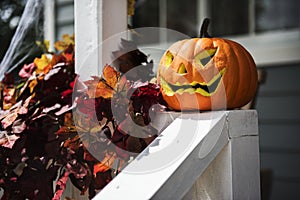 Halloween pumpkins and decorations outside a house