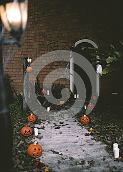 Halloween pumpkins and decorations outside a house