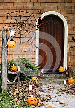 Halloween pumpkins and decorations outside a house