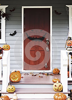 Halloween pumpkins and decorations outside a house