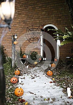 Halloween pumpkins and decorations outside a house