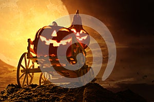 Halloween pumpkins on farm wagon at spooky in night of full moon