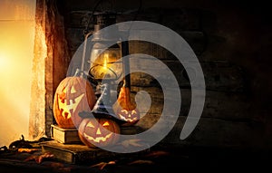 Halloween pumpkins and lantern in an old house by the window where the moonlight shines