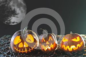 Halloween pumpkins at wood background. Carved scary faces of pumpkin.