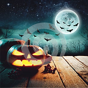 Halloween Pumpkins On Wood In A Spooky Forest At Night. Elements of this image furnished by NASA