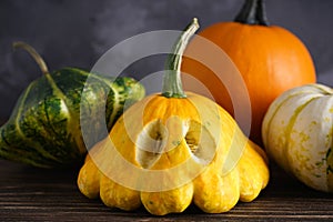 Halloween pumpkins on wooden table, close-up. Halloween composition