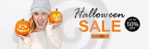 Halloween sale with woman holding pumpkins