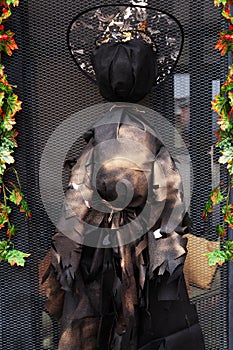 Halloween. Scarecrow of a festive witch black and gold