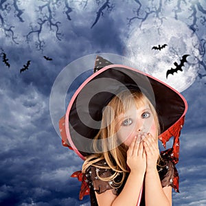 Halloween scared kid girl on dark moon sky