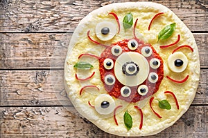 Halloween scary food funny eye monster pizza margherita snack with mozzarella cheese