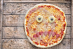 Halloween scary food funny monster face pizza horror snack with mozzarella