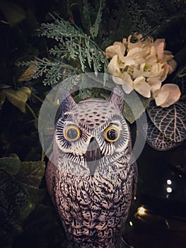 Halloween scene : Cute owl figure sculpture made from paper mache decorated with multi flower and tree branch