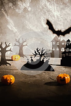 Halloween scene.  Paper houses and dark misty trees in  graveyard