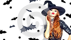 Halloween Sexy Girl wearing witch costume with a hat. Party, Celebrating. Beauty Woman with long hair and holiday bright makeup