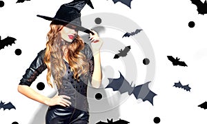 Halloween Sexy Girl wearing witch costume with a hat. Party, Celebrating. Beauty Woman with long hair and holiday bright makeup