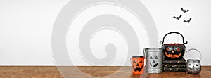 Halloween shelf display with rustic jack o lantern candle holder decor against a white wall