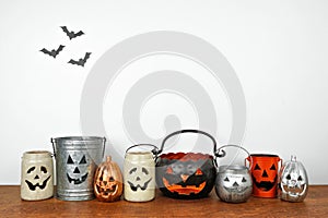 Halloween shelf display with rustic jack o lantern candle holder decor against a white wall