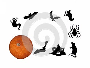 Halloween silhouettes and a pumpkin against white background flat lay. Halloween concept photo