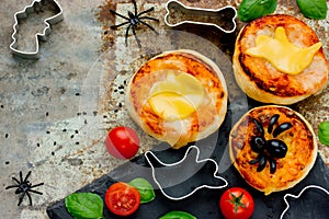 Halloween snack pizza for kids decorated cheese and olive