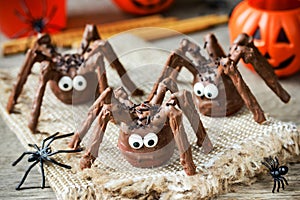 Halloween spider cakes with candy eyes in chocolate, Halloween treats