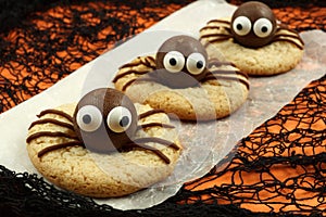 Halloween spider cookies with orange and black background