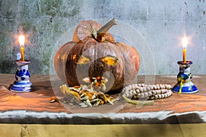 Halloween still life with pumpkins, candles and rosary
