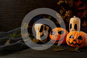 Halloween Stingy Jack pumpkins on rustic background, copy space