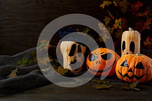 Halloween Stingy Jack pumpkins on rustic background, copy space photo