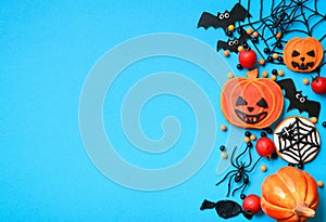 Halloween sweets and decorations on blue background