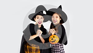Halloween thema, young asian women in witch costume posing in white background. halloween party concept