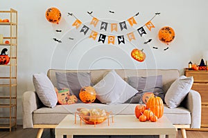 Halloween theme decorated living room. Lifestyle Halloween season family house interior. Traditional Halloween