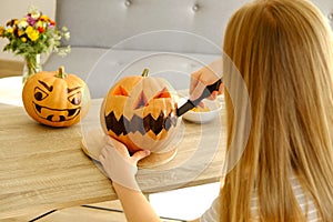 Halloween themed image with carved pumpkins in house party environment.