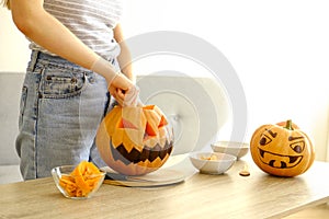 Halloween themed image with carved pumpkins in house party environment.