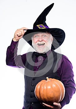 Halloween traditions. evil wizard hold orange pumpkin. bearded man ready for halloween party. Stargazer in holiday