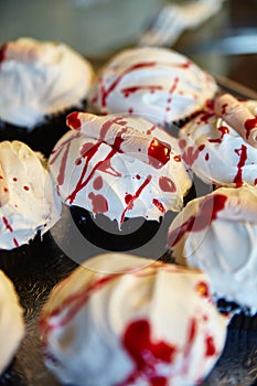 Halloween treat cupcakes with edible finger covered in red blood sauce