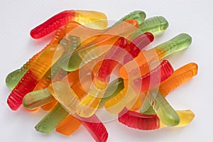 Halloween treats gummy worms. Colorful jelly candies on white background. Top view