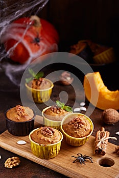 Halloween treats. Muffins with pumpkin, walnuts and cinnamon