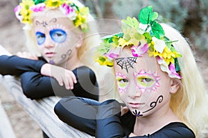 Halloween twin sisters with sugar skull makeup