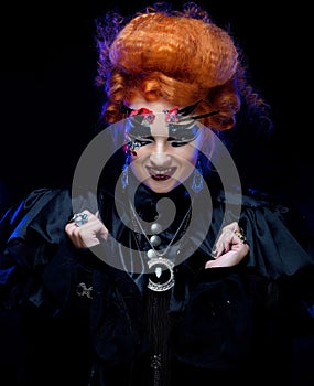 Halloween Vampire Woman portrait. Beautiful Glamour Fashion Sexy Vampire Lady with red hair.