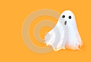 Halloween white spooky ghost spirit on orange backgrounds. Minimal concept scary autumn