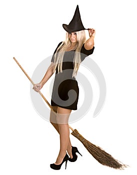 Halloween witch in black dress and hat on broom.