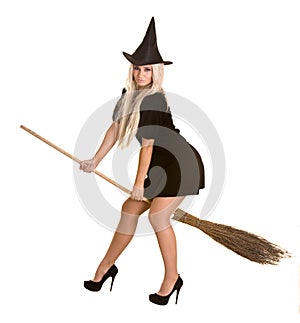 Halloween witch in black dress and hat, broom.