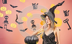 Halloween Witch with a carved Pumpkin and magic lights in a dark forest. Halloween party. Models Posing on