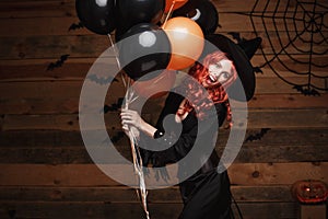 Halloween Witch Concept - Beautiful caucasian woman in witch costumes celebrating Halloween posing with posing with orange and bla