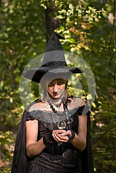 Halloween Witch with Crystal Ball in the Forest