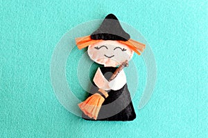 Halloween witch doll on a blue felt background. Halloween decor toy instructions step. Top view. Closeup