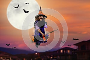 Halloween witch flying broom. Huge moon and bat