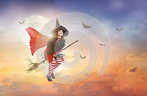 Halloween witch flying broom. Huge moon and bat