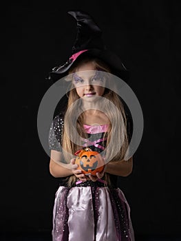 Halloween witch girl with candy bucket